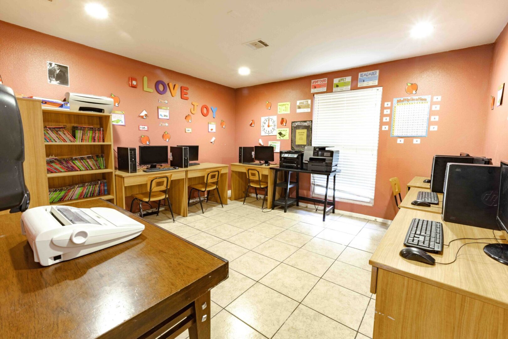 Computer lab with multiple workstations and colorful wall decor.