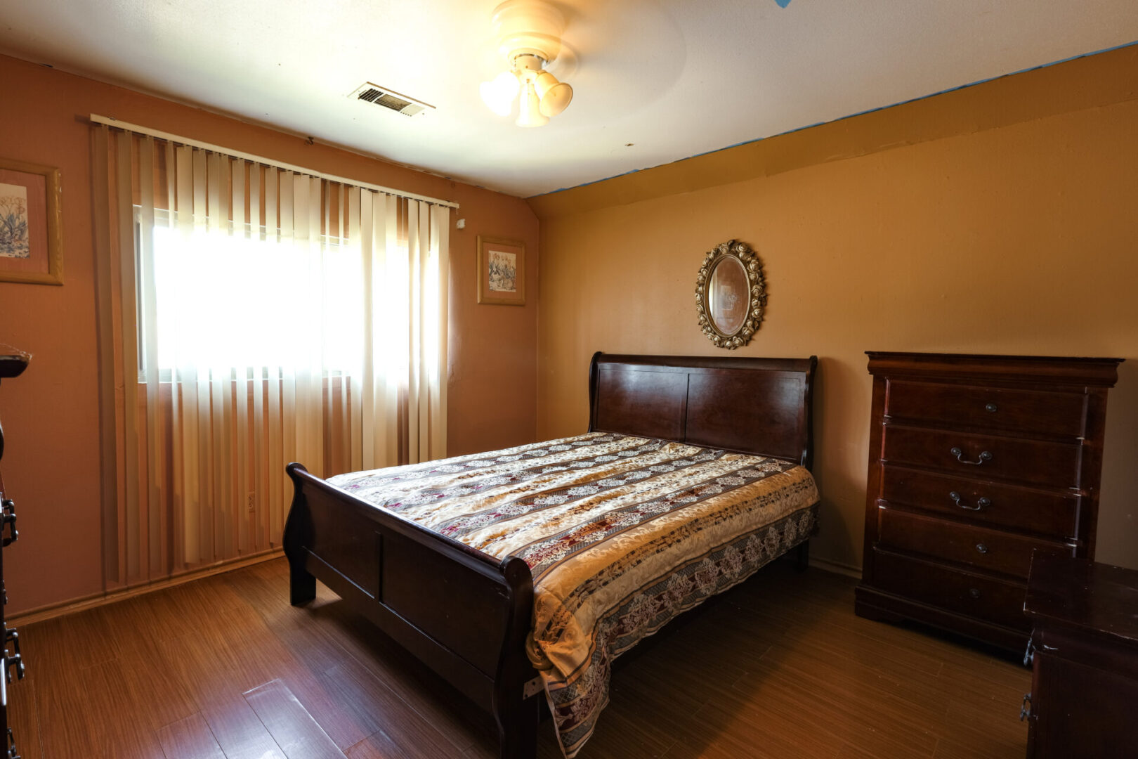 Cozy bedroom with warm lighting and wooden furniture.