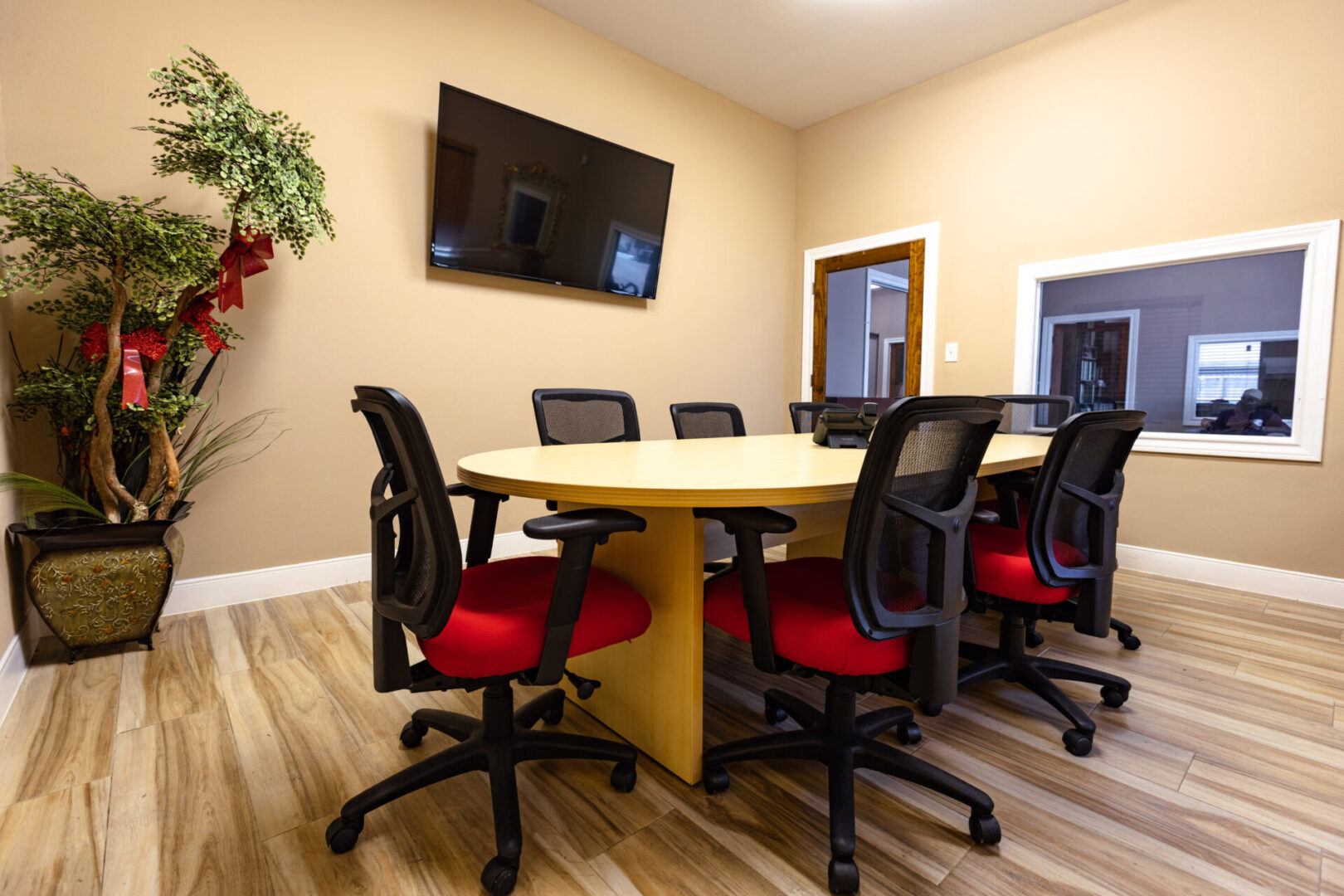 Modern conference room with large table and ergonomic chairs.